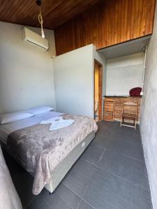 a bedroom with a bed and a desk in it at Pousada Bonetti Quarto 8 in Santa Rosa