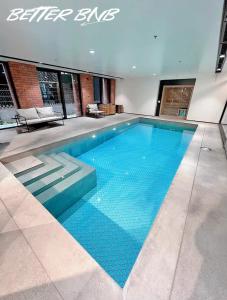a large swimming pool in a building at Bloom Central – Pool & Gym in Wellington