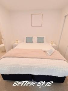 a bedroom with a large bed with a white bedspread at Bloom Central – Pool & Gym in Wellington