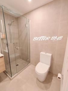 a bathroom with a shower stall and a toilet at Bloom Central – Pool & Gym in Wellington +18 photos