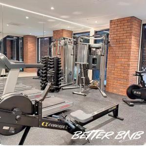 a gym with several equipment in a room at Bloom Central – Pool & Gym in Wellington