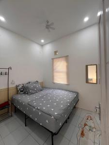 a bedroom with a bed and a ceiling fan at Homestay Rancabango A4 Garut in Tarogong