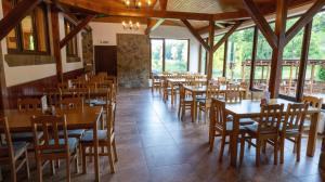 a dining room with wooden tables and chairs at Pod Břesteckou skalou in Břestek