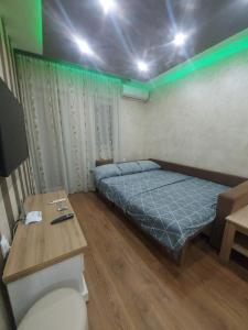 a bedroom with a bed and a wooden table at Perisic Apartman Obrenovac, sa parkingom in Obrenovac +22 photos