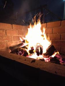 a fire in a brick oven with flames at Casa Rústica Diaz in Ica