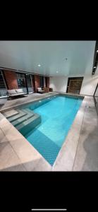 a large swimming pool in a building at The Urban Nest 613 in Wellington