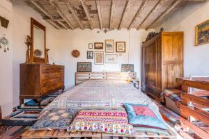 a bedroom with a large bed and a wooden dresser at Selvatica50 b&b in Nonantola