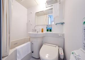 a small bathroom with a toilet and a sink at Super Hotel JR Nara Ekimae Sanjo Dori in Nara