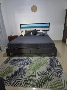 a bedroom with a bed and a rug at Ocean view in Pointe aux Biches +5 photos