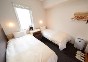 a hotel room with two beds and a window at Super Hotel JR Nara Ekimae Sanjo Dori in Nara +62 photos