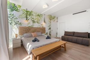 a bedroom with a large bed and a couch at Villa Marbella Eilat in Eilat +16 photos