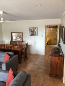 a living room with a couch and a table at Seaview on Kent in Rockingham