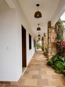 a hallway of a house with a stone wall at Pousada Brisa leve Paraty in Paraty