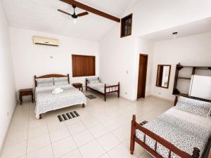 a living room with two beds and a couch at Pousada Brisa leve Paraty in Paraty