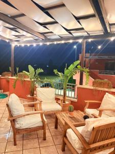 a patio with chairs and a table and a view at Villaelena Salento Mare in Marittima