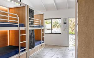 a room with bunk beds and a hallway at Wake Up! Byron Bay in Byron Bay