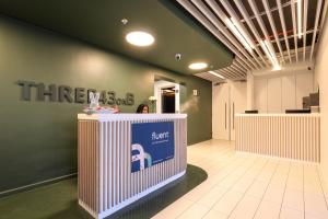 a hallway with a first aid counter in a store at THREE43 ON B - Fluent Serviced Apartments in Cape Town