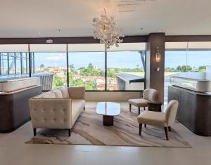 a living room with a couch and a table at oneTree Plaza Hotel Cebu in Cebu City +24 photos