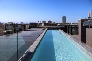 a swimming pool on the roof of a building at THREE43 ON B - Fluent Serviced Apartments in Cape Town