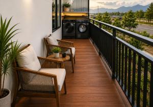 a balcony with chairs and a washing machine at Solwind Riverside in Danang