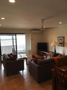a living room with a couch and a table at Seaview on Kent in Rockingham