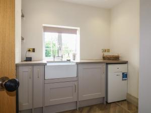 a kitchen with a sink and a window at Ivet Lowe in Matlock +27 photos