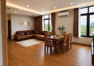 a living room with a table and a couch at Solwind Riverside in Danang