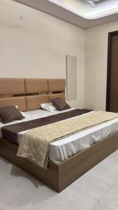 a bedroom with a large bed in a room at Hotel Awadh Grand in Kānpur +22 photos