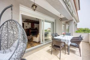 a dining room with a table and chairs at Pool & Garden Apartment Bakija - Happy Rentals in Pakoštane