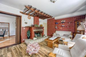 a living room with a brick wall at Pool & Garden Apartment Bakija - Happy Rentals in Pakoštane