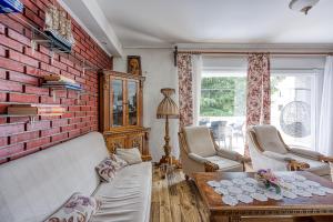 a living room with a brick wall at Pool & Garden Apartment Bakija - Happy Rentals in Pakoštane
