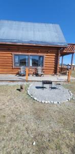 a log cabin with a picnic table in front of it at Mothers Modern Lakeside Cabin in Khyaktil