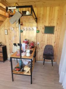 a room with a desk and a chair in a room at Mothers Modern Lakeside Cabin in Khyaktil +5 photos