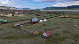 an aerial view of a farm with houses and buildings at Mothers Modern Lakeside Cabin in Khyaktil