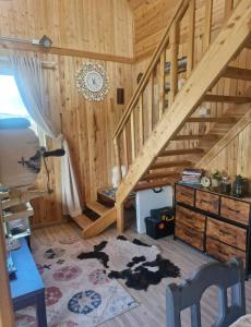 a room with a wooden staircase in a cabin at Mothers Modern Lakeside Cabin in Khyaktil