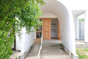 an entrance to a house with an archway at Regions Hostel in Yokote