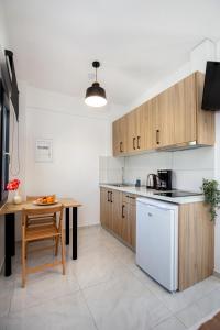 a kitchen with wooden cabinets and a wooden table at O-live in Prinos