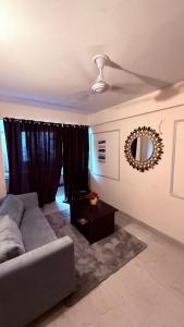 a living room with a couch and a table at Savera hommes in Ghaziabad