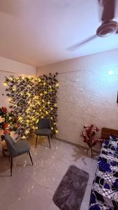 a room with two chairs and a wall of wine bottles at Savera hommes in Ghaziabad