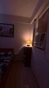 a room with a bed and a lamp on a table at Savera hommes in Ghaziabad +6 photos