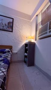 a bedroom with a bed and a table with a lamp at Savera hommes in Ghaziabad