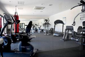 a gym with treadmills and machines in a room at Barefoot Bliss in Rockingham