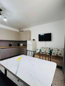 a kitchen with a white table in a room at Balor152 in Koshkolʼ +3 photos