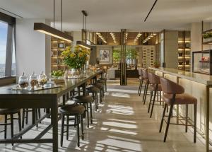 a dining room with a long table and chairs at Park Hyatt Kuala Lumpur in Kuala Lumpur