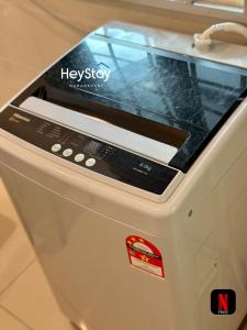 a washer with a screen on top of it at Villa 20Pax4B3B PrivatePool /Karaok/Pooltable/BBQ in Malacca