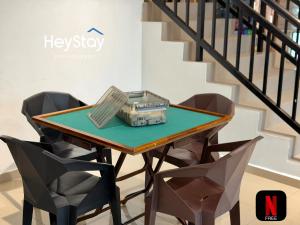a table with two chairs and a laptop on it at Villa 20Pax4B3B PrivatePool /Karaok/Pooltable/BBQ in Malacca