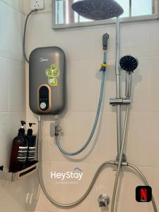 a shower in a bathroom with a shower head at Villa 20Pax4B3B PrivatePool /Karaok/Pooltable/BBQ in Malacca +54 photos