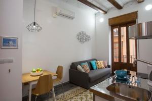 a kitchen and living room with a couch and a table at Eco-Friendly Apartments in Valencia