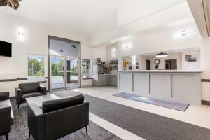 a living room with a couch and a table at Days Inn by Wyndham Valemount in Valemount