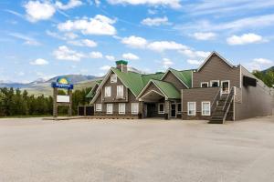 a large house with a sign in front of it at Days Inn by Wyndham Valemount in Valemount